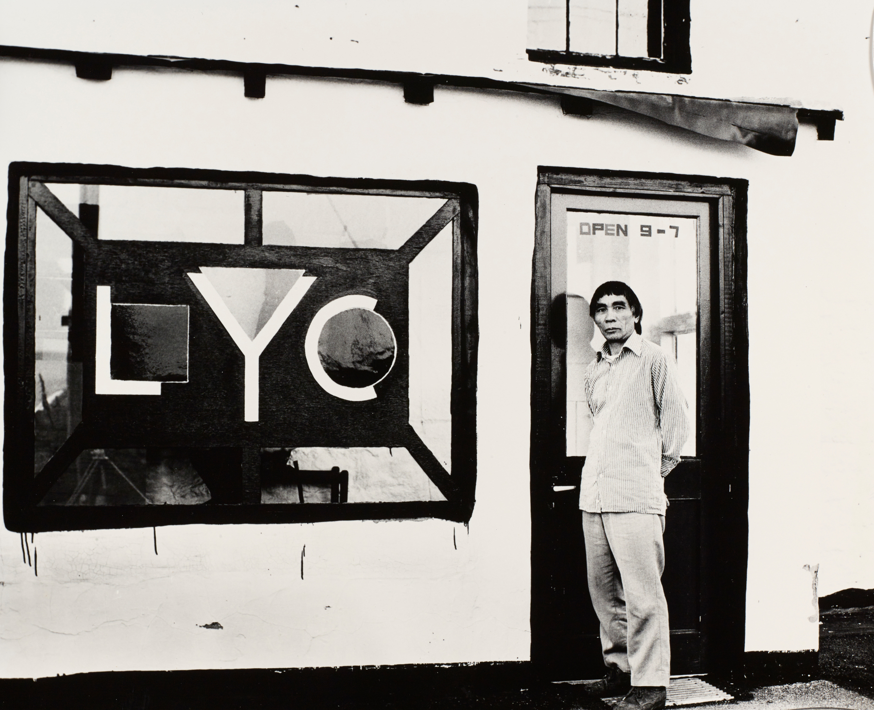 Li Yuan-chia standing at the porch of the LYC Museum & Art Gallery, featuring window designed by David Nash. Image courtesy of Li Yuan-chia Archive, The University of Manchester Library